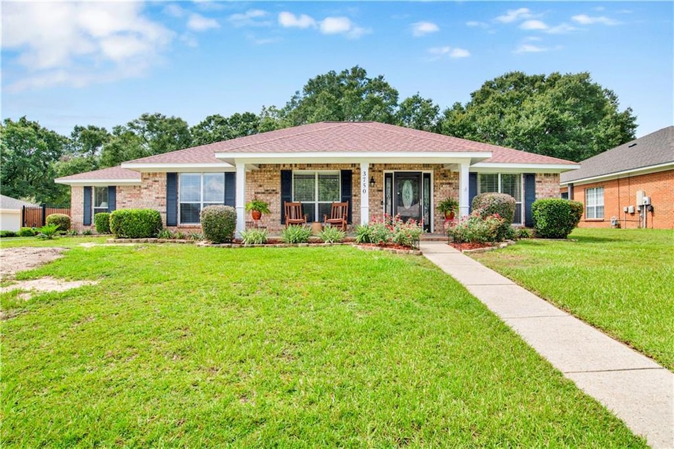Ranch-style home with a front lawn and a porch