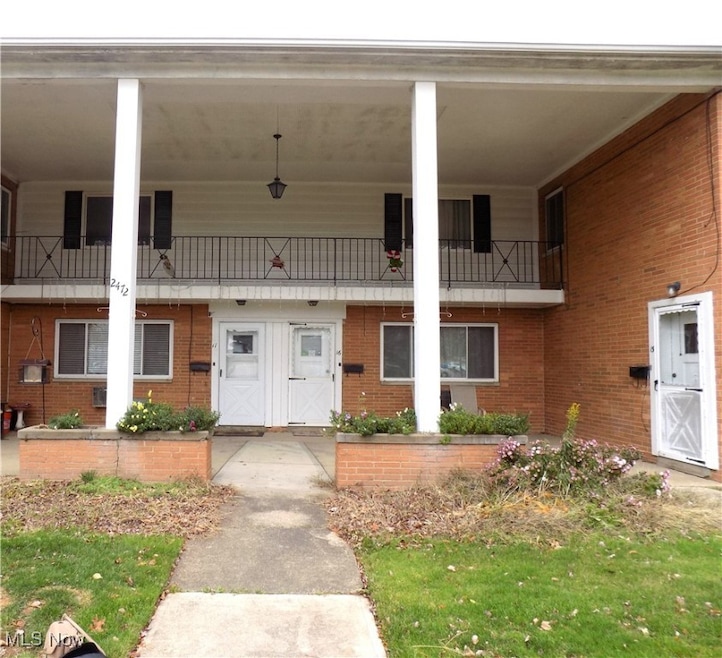 Doorway to property featuring brick siding