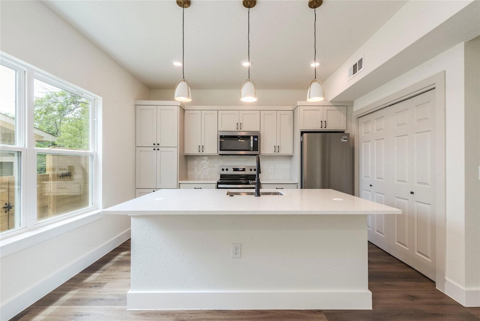 Kitchen featuring appliances with stainless steel
