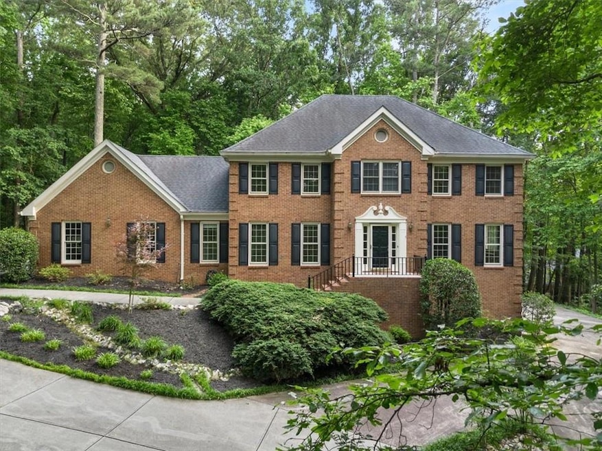 View of front of property with brick siding and a shingled roof