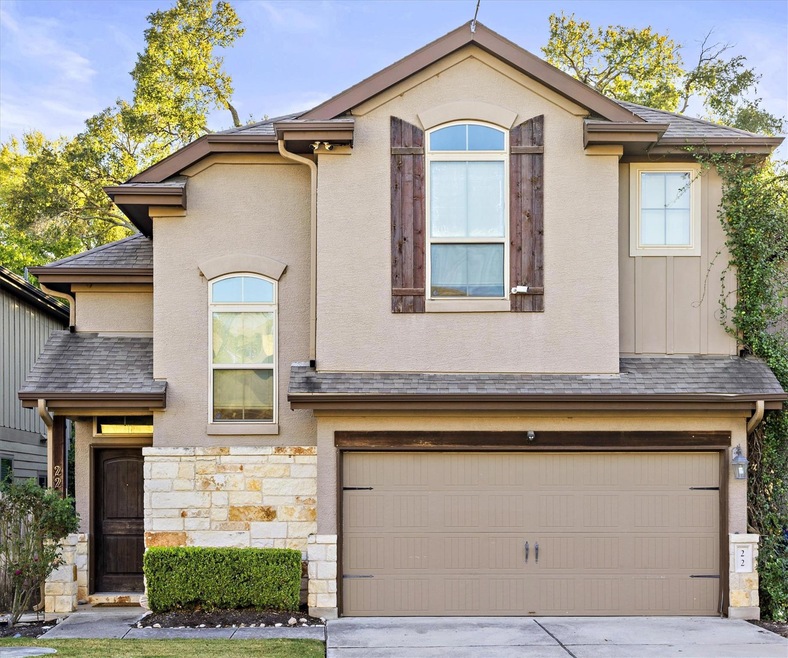 View of front of house featuring a garage, drivew