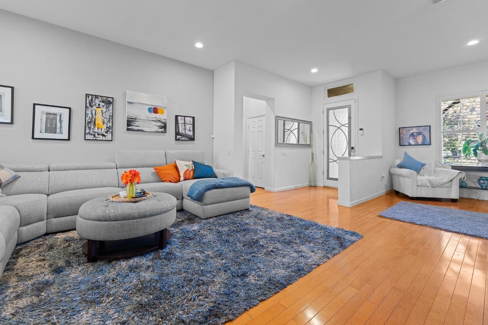 Living area view with light wood-type flooring and recessed lighting