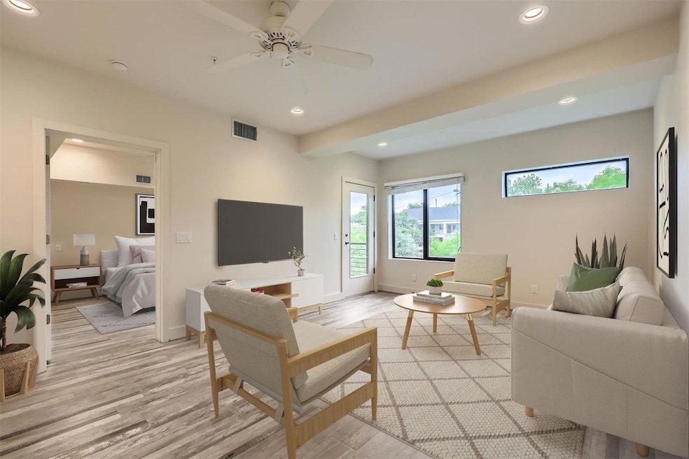 Living area featuring baseboards, light wood-styl