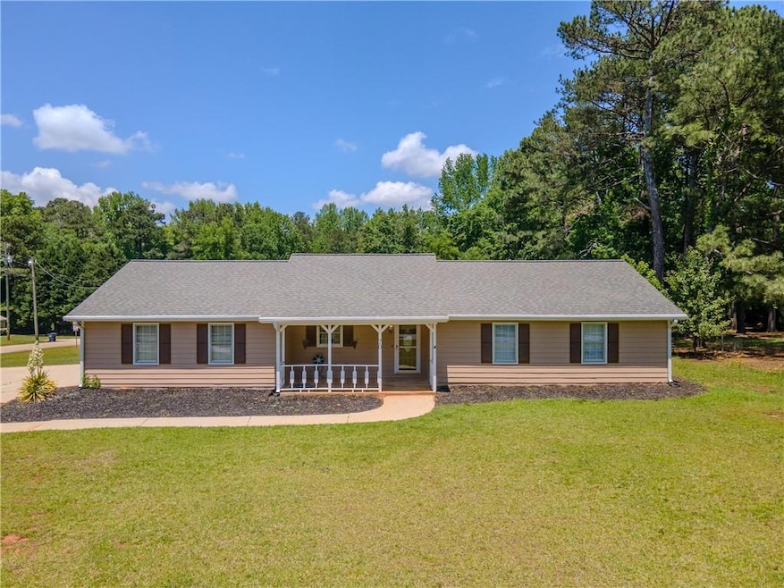 Single story home featuring covered porch, a front