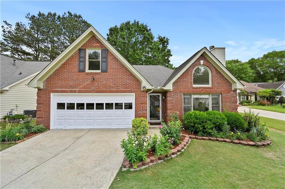 Traditional home with concrete driveway, brick sid