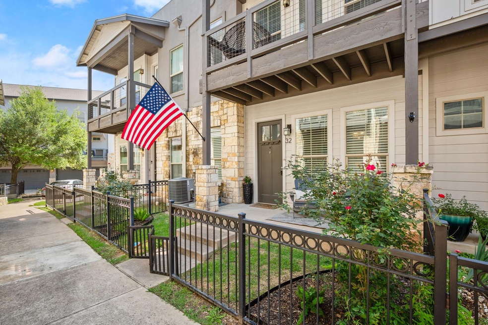 View of exterior entry featuring a balcony, stone