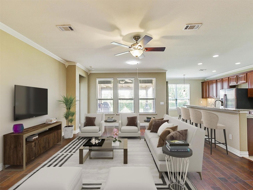 Living room featuring ceiling fan, dark wood-type 