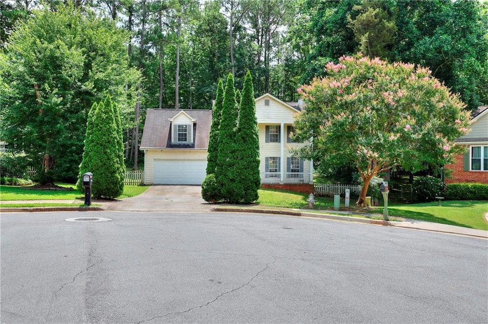 View of front of home with concrete driveway and a garage