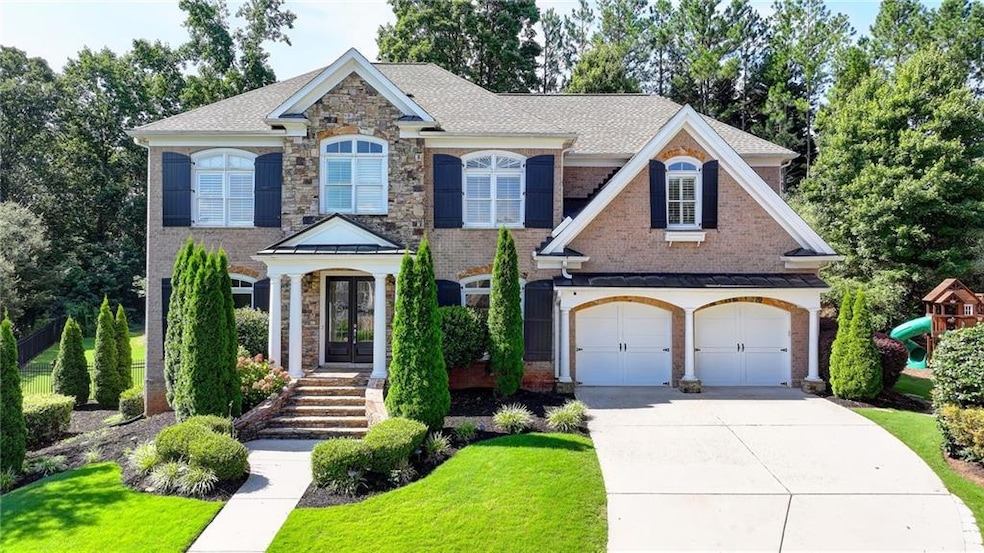 View of front facade featuring concrete driveway, roof with shingles, an attached garage, a front yard, and brick siding