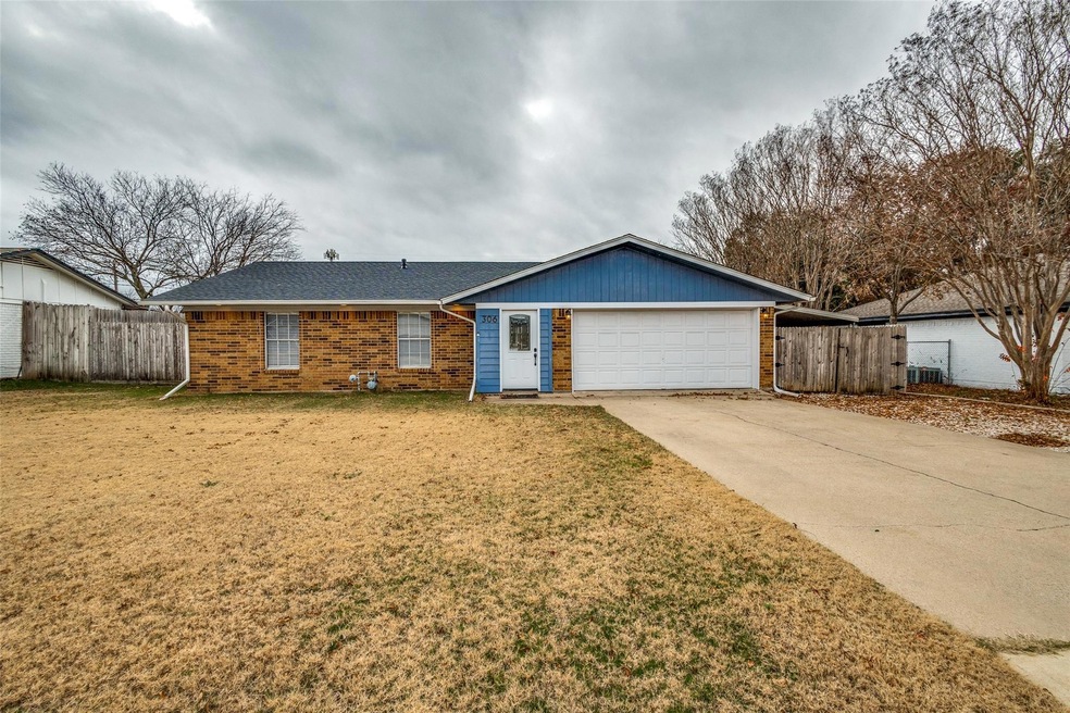 Ranch-style house with a garage and a front lawn