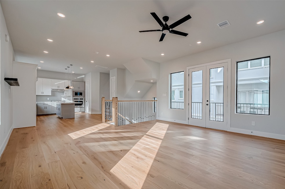 A spacious, open-concept living area with hardwood