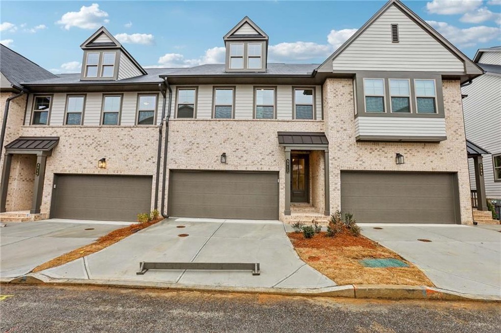 Townhome / multi-family property featuring a garag