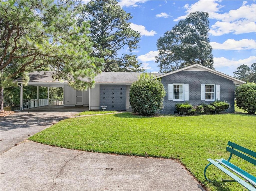 View of front of house with a carport and a front 