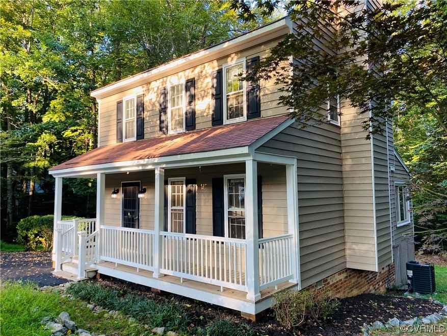 View of front of house with a porch and central air condition unit