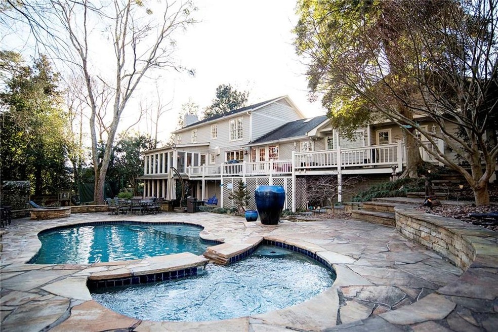 Beautiful rear view of home with custom heated poo