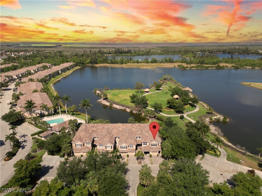 Birds eye view of property with a water view