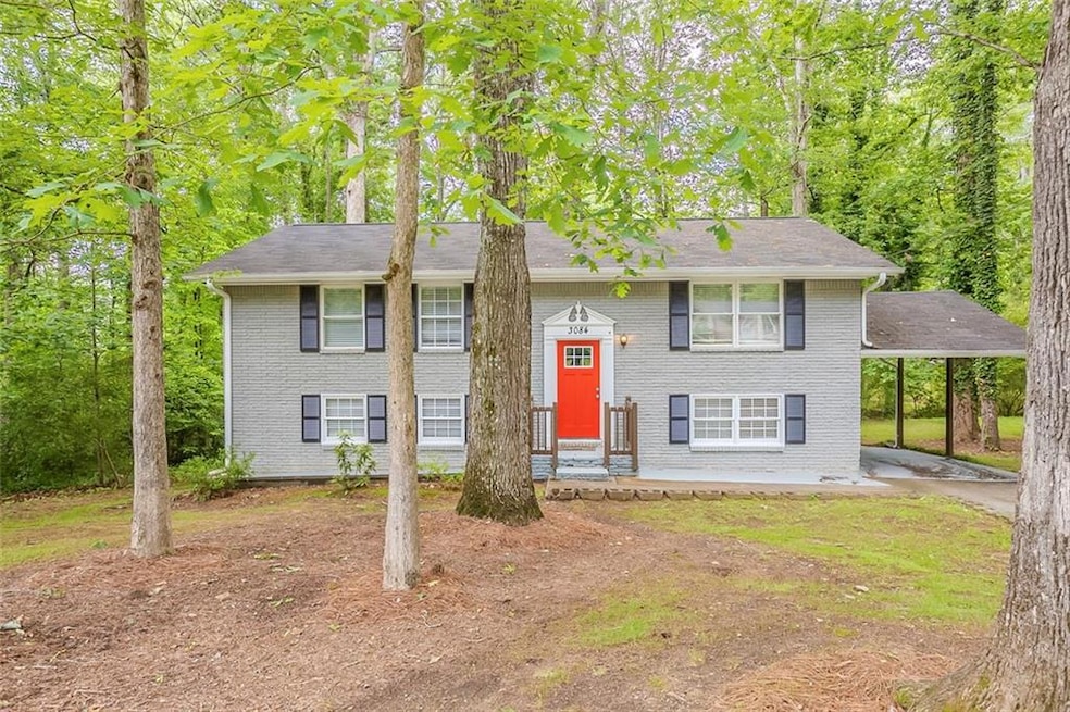 Raised ranch with brick siding and driveway
