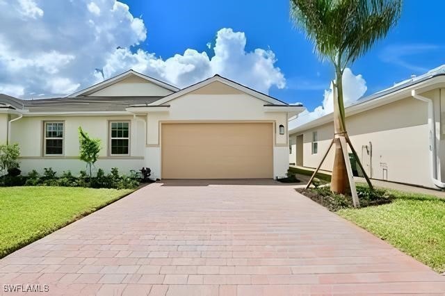 Ranch-style home with stucco siding, decorative dr