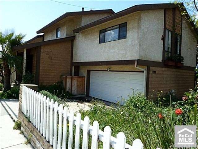 Corner unit with side yard and attached garage.