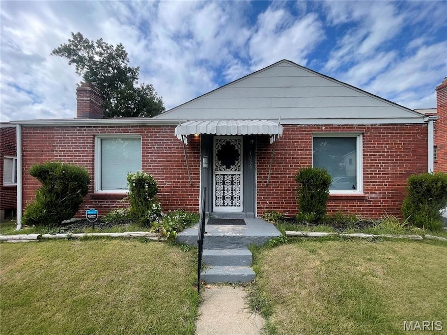 Bungalow-style house featuring a front lawn, brick siding, and a chimney
