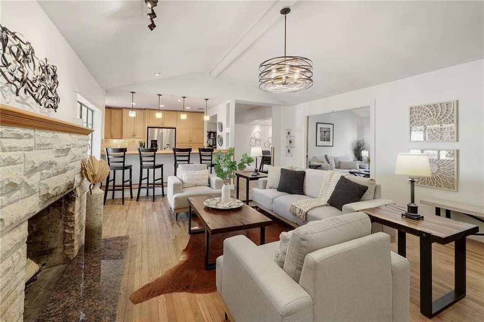 Living room features original limestone fireplace
