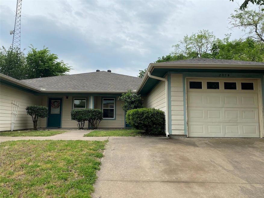 Ranch-style home with an attached garage, driveway