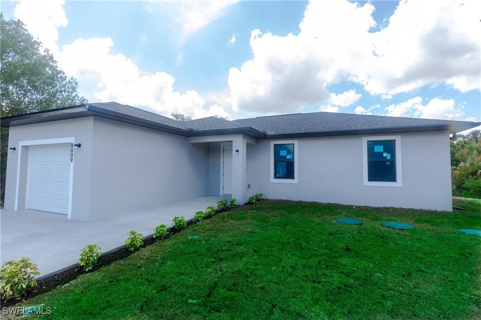 Single story home featuring a garage, stucco sidin