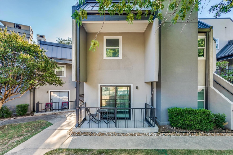 View of front of property featuring stucco siding and a metal roof