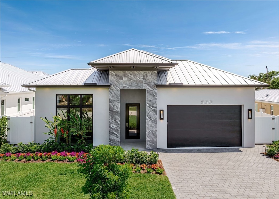 Contemporary home featuring a standing seam roof,
