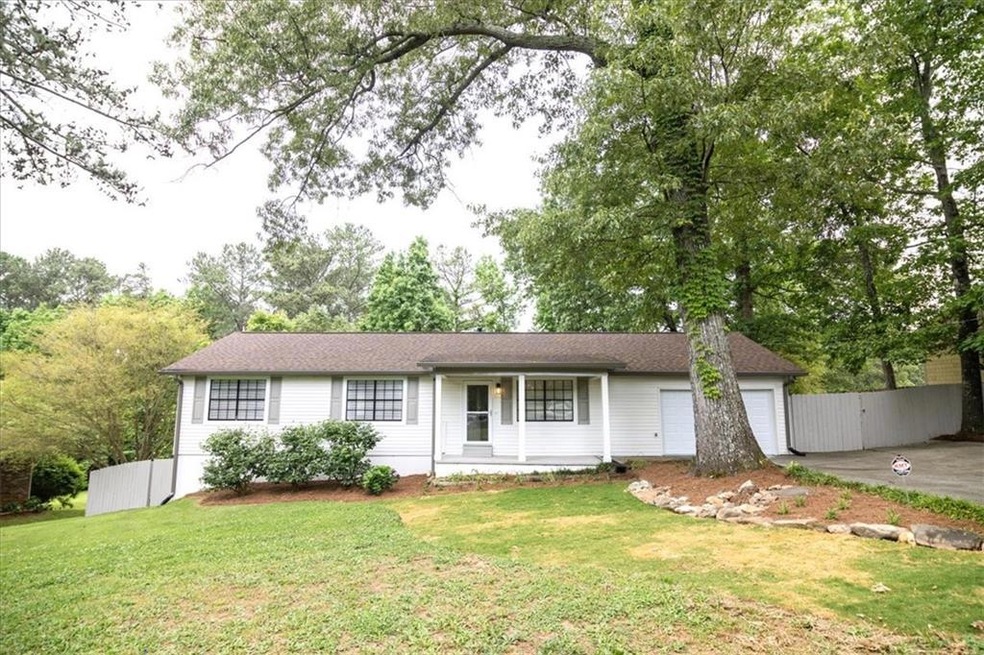 Single story home featuring a garage and a front l