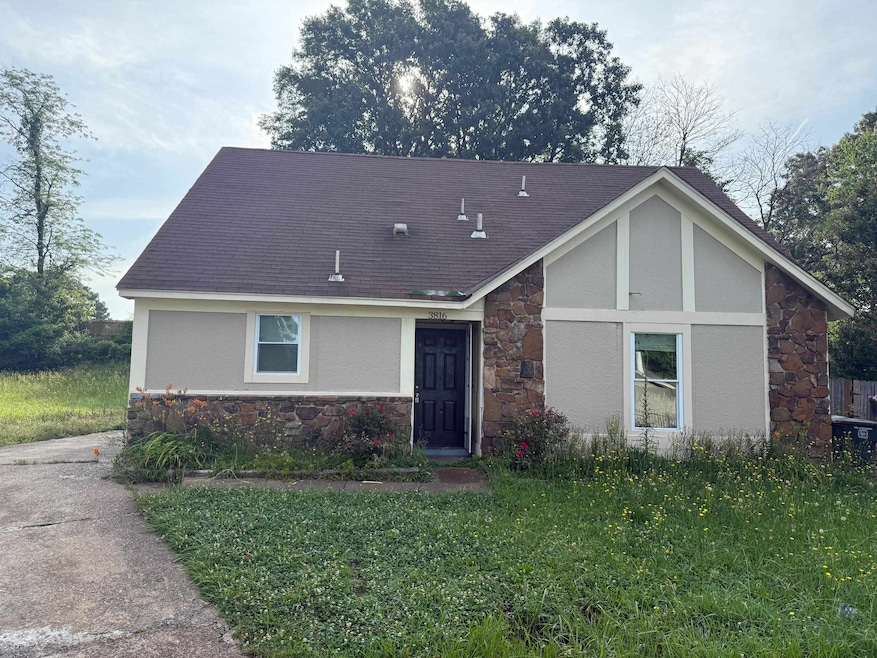 View of front of house featuring stone siding, stucco siding, and roof with shingles