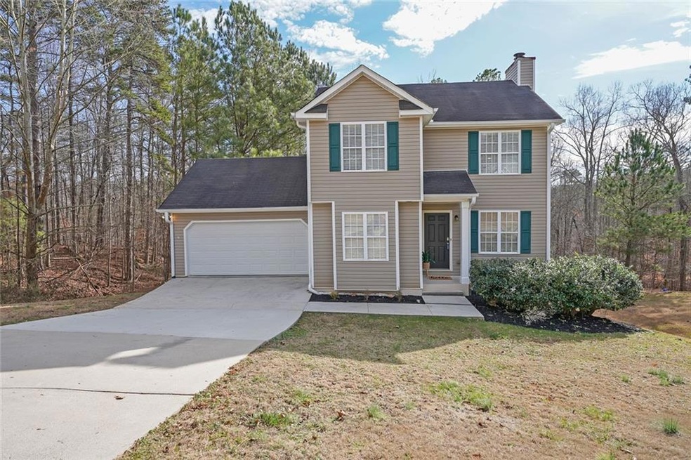 View of front of property with a garage and a front lawn
