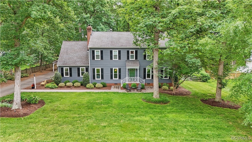 Colonial-style house with roof with shingles, a ch
