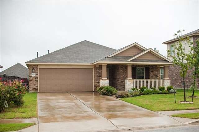 Front view with mature rose bushes along drive. Ni