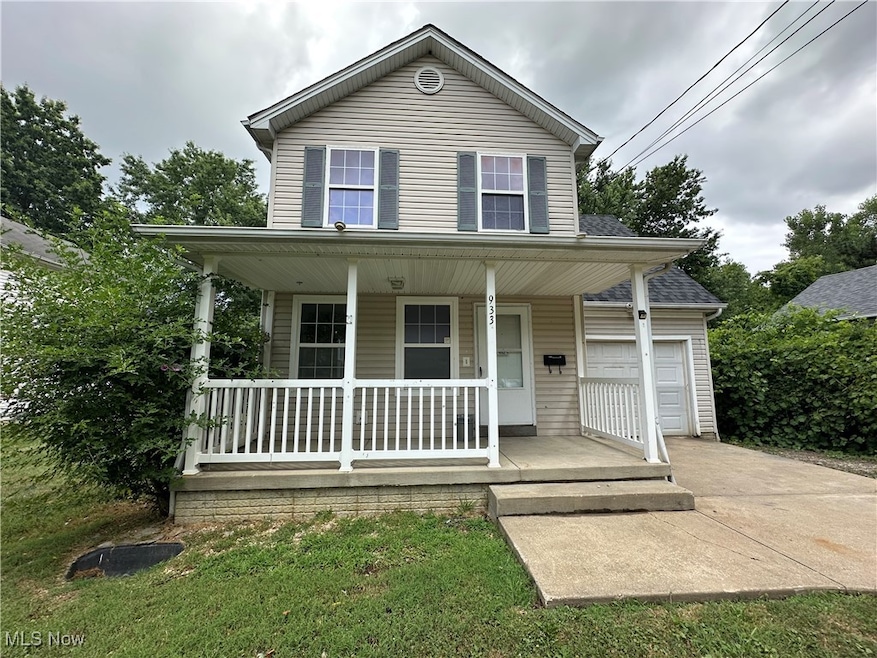 View of front of home with a porch and a garage