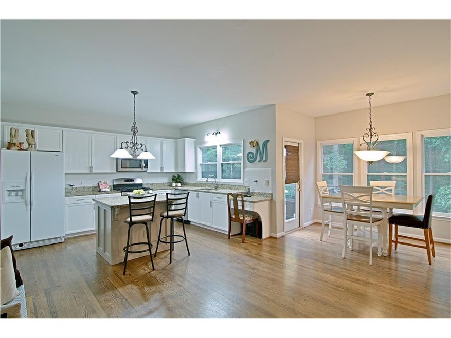 Wonderful Kitchen perfect for entertaining or family gatherings. Hardwood floors, granite, stainless, new dishwasher, island, dining area surrounded by windows & cozy fireside Keeping Room!