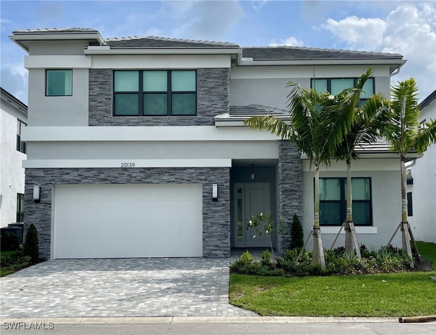 View of front facade with a garage and a front yar