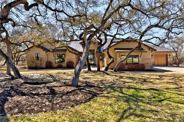 Mature trees shade the beautiful front yard