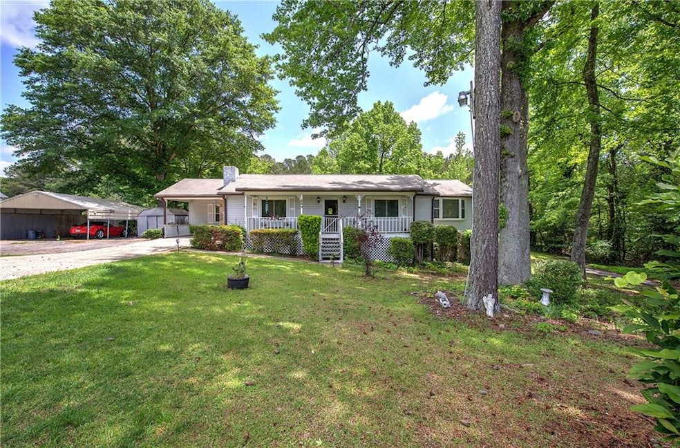 Ranch-style house featuring covered porch, concret