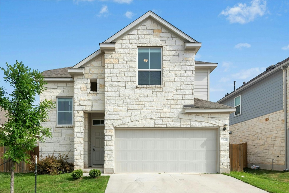French country style house with stone siding, dri