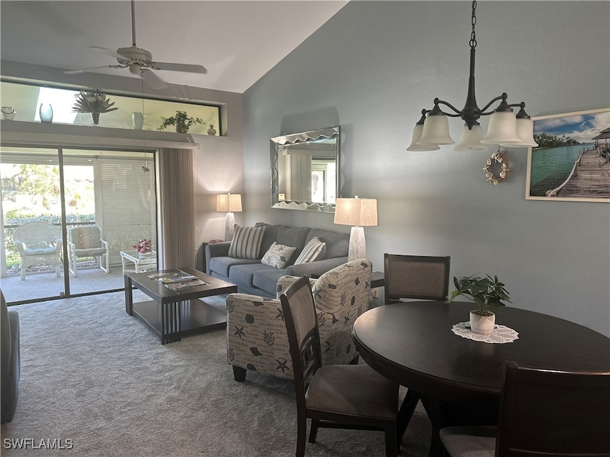Living room featuring carpet flooring, high vaulte