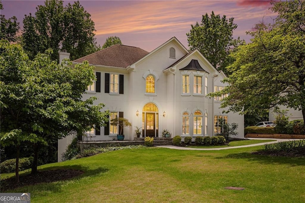 French country home featuring a chimney, stucco si