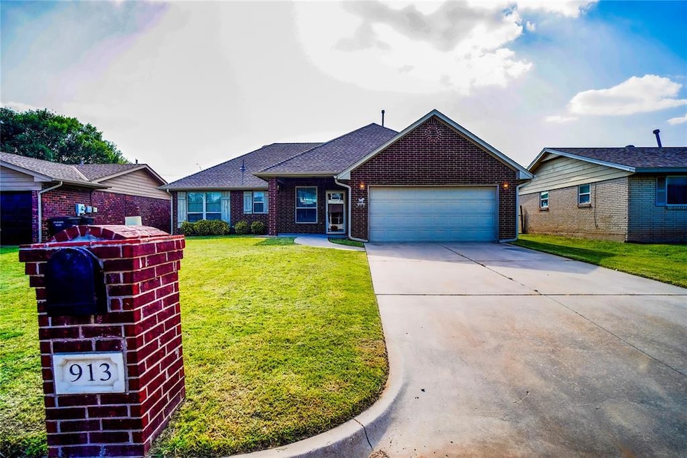 Ranch-style house with driveway, a front yard, a garage, roof with shingles, and brick siding