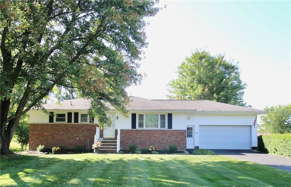 Single story home featuring a front yard and garag