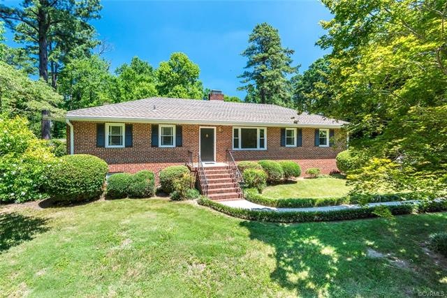 This large corner lot is filled with mature landsc