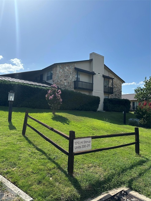 View of side of property featuring stone siding a