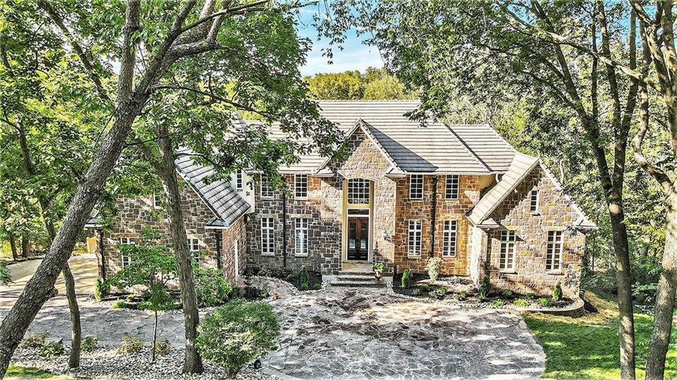 Estate sits on 1.175 acres with lots of trees and privacy. Slate roof, Hackett Stone front and heated driveway.