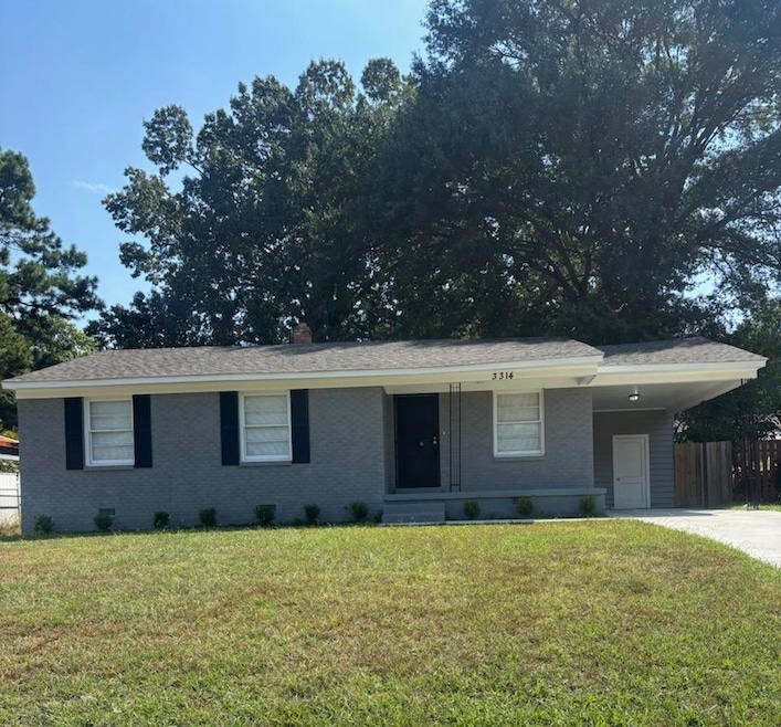 Single story home with a carport, brick siding, concrete driveway, and covered porch