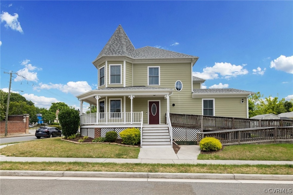Victorian home with a front lawn and covered porch