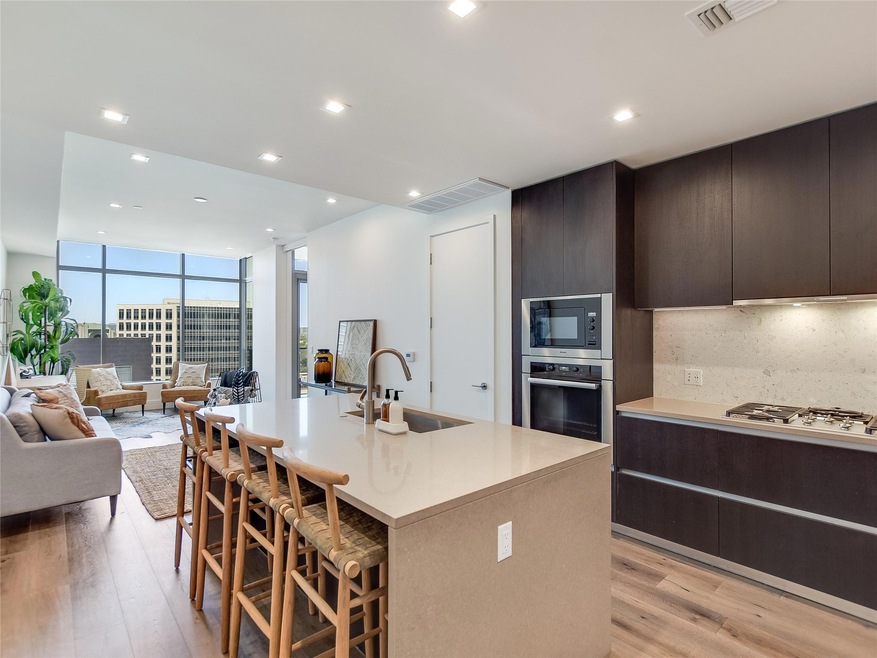 Kitchen with a sink, light wood-style floors, a b